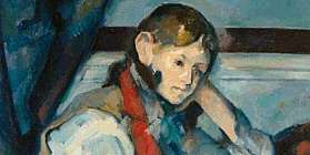 Bild vo eme junge, wo nachdenkend anere Tisch sitzt und liest