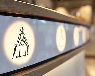 Close-up of a lit wall with illustrations.