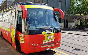 Red sightseeing bus in Basel on the street.