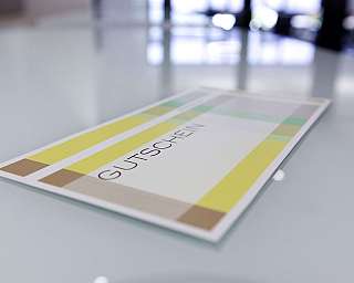 A voucher with colourful stripes on a table.